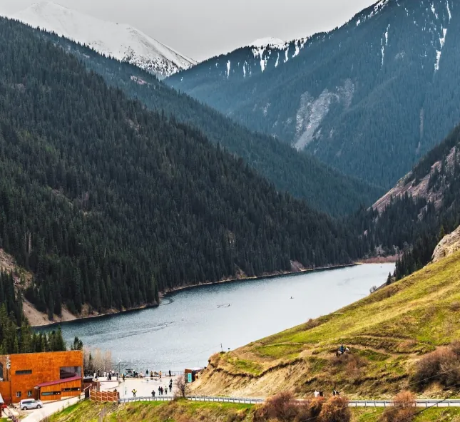 Mountain lake between forested slopes